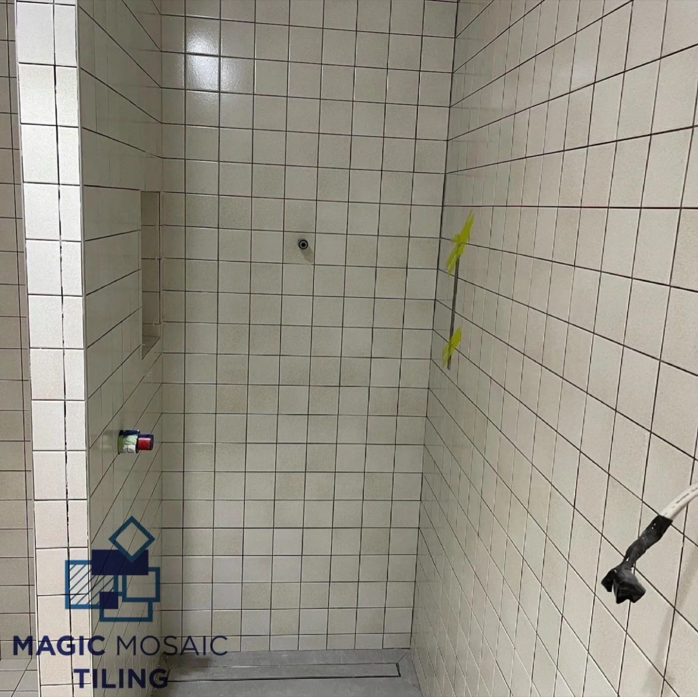 Square tile shower with a strip drain