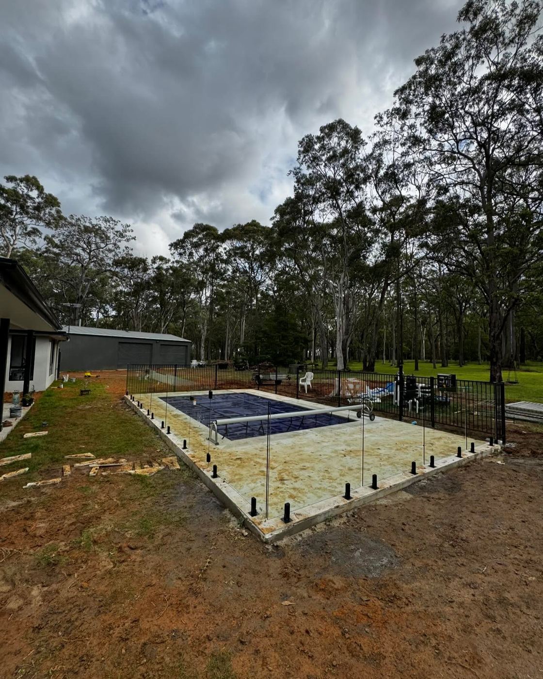 Frameless glass pool fencing on a rural property