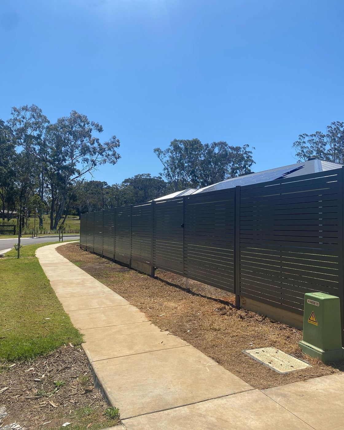 Charcoal aluminium slat fence built by Xtreme Fencing